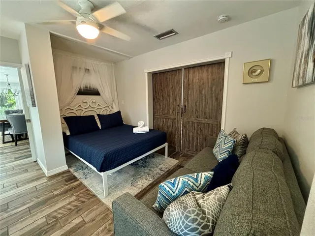 a bedroom with a bed and a mirror