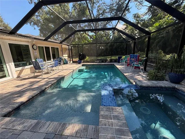 a view of a patio with table and chairs potted plants with wooden floor and fence