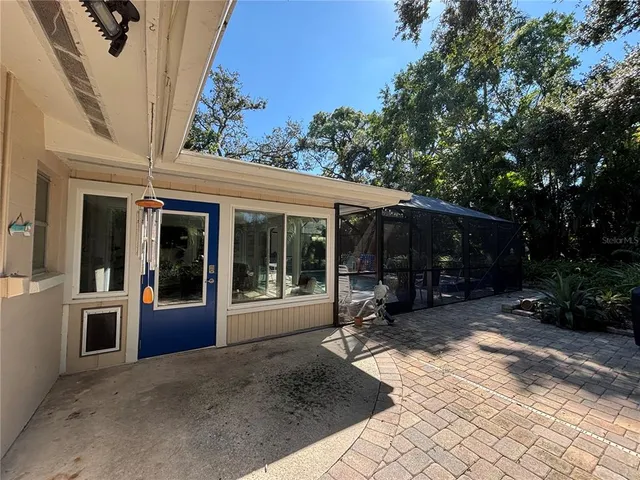 a view of a house with backyard outdoor seating area