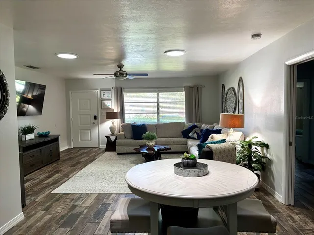 a living room with furniture a window and a table