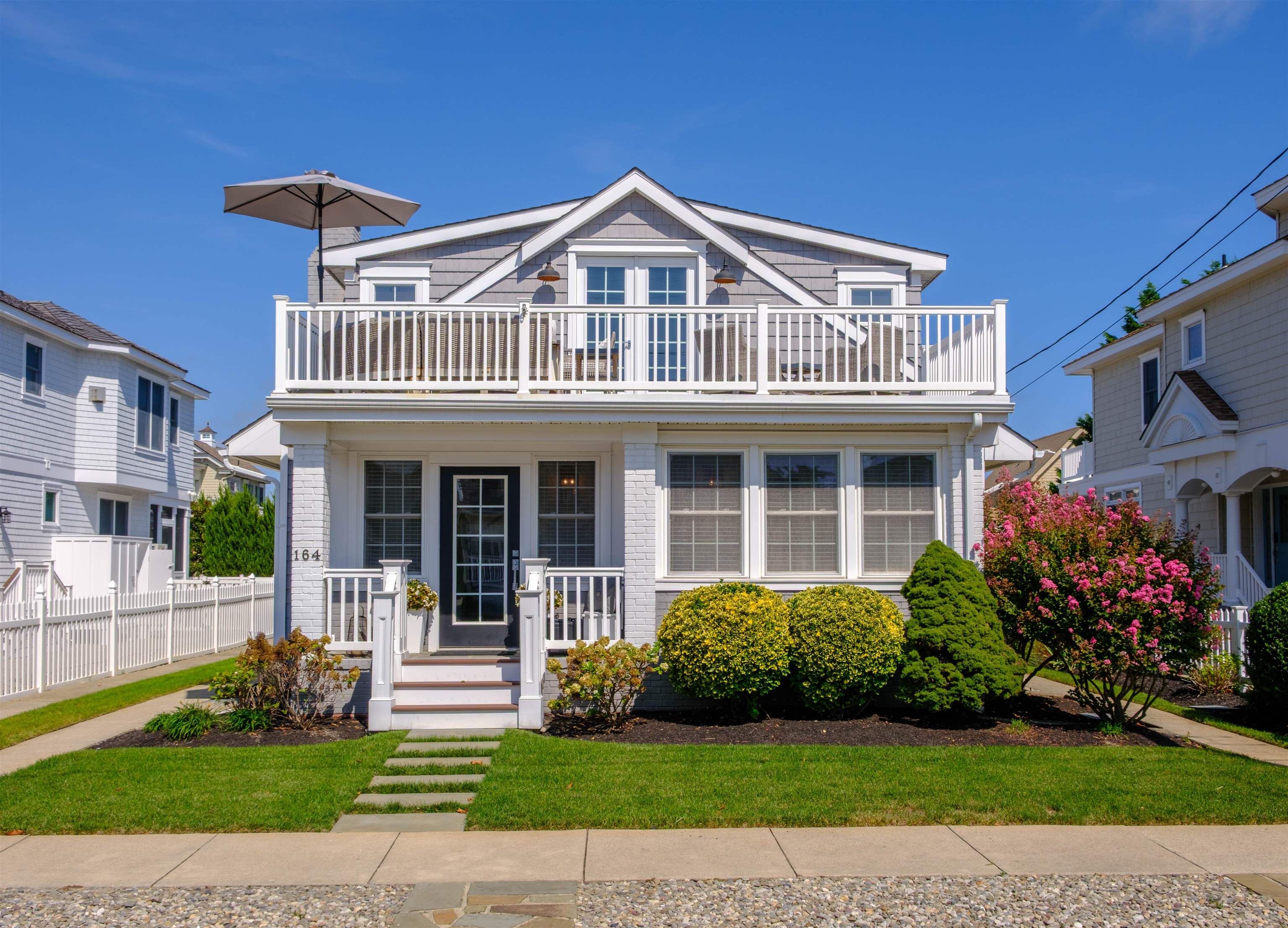 164 93rd Street Stone Harbor, NJ 08247 - Photo 1 of 47 a front view of a house with a garden