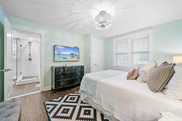 a bedroom with a bed and a chandelier