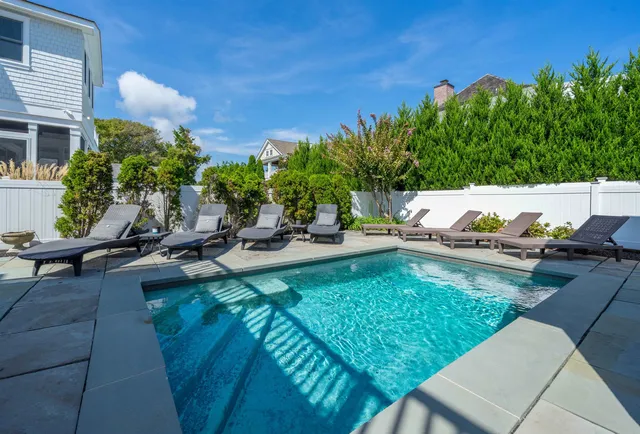a view of a swimming pool with chairs
