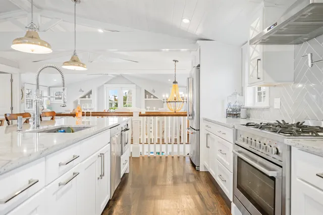 a kitchen with stainless steel appliances granite countertop a stove and a sink
