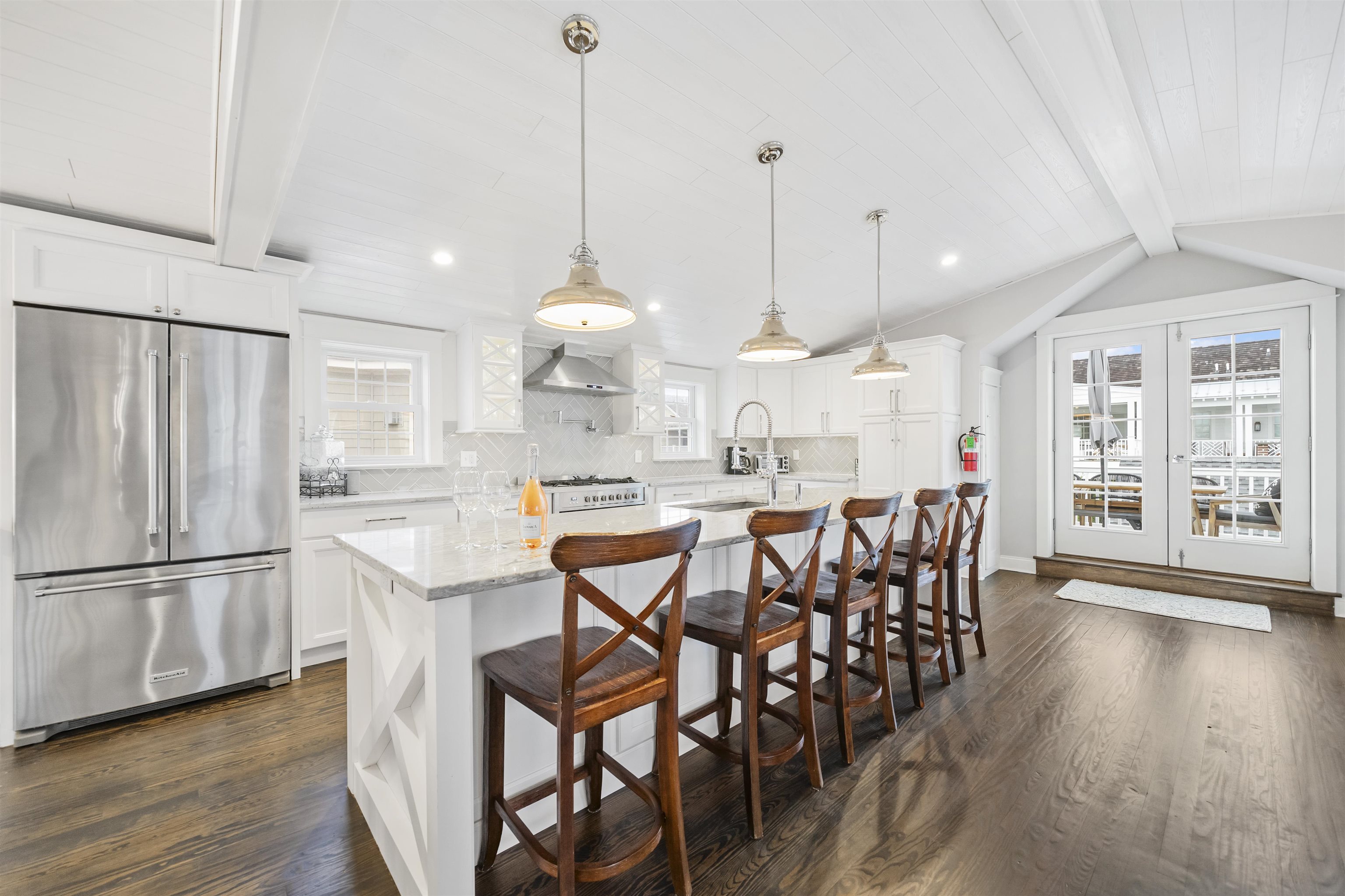 164 93rd Street Stone Harbor, NJ 08247 - Photo 35 of 47 a kitchen with stainless steel appliances a dining table chairs sink and cabinets
