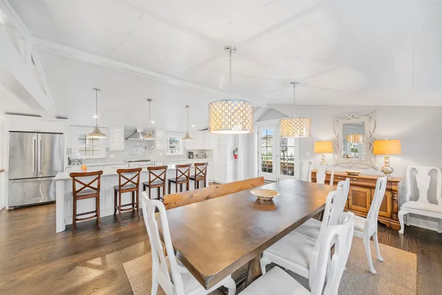 a dining room with furniture window and wooden floor