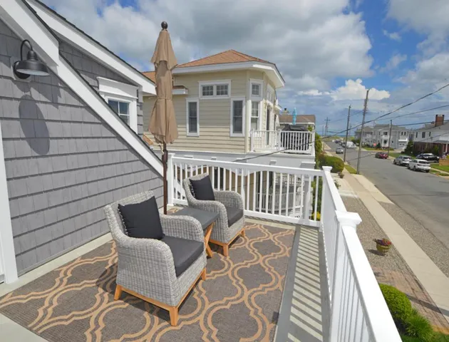 a view of a chair and tables in the balcony