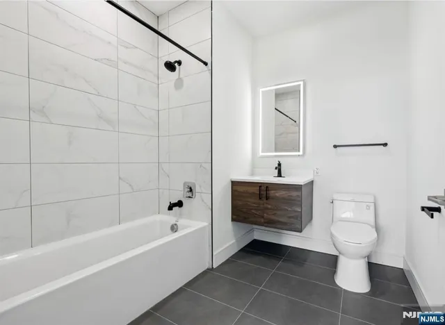 a bathroom with a sink a toilet and bathtub