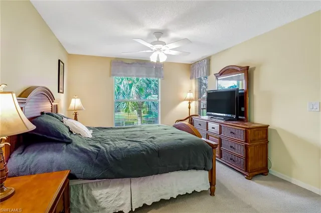 a bedroom with a bed and a television