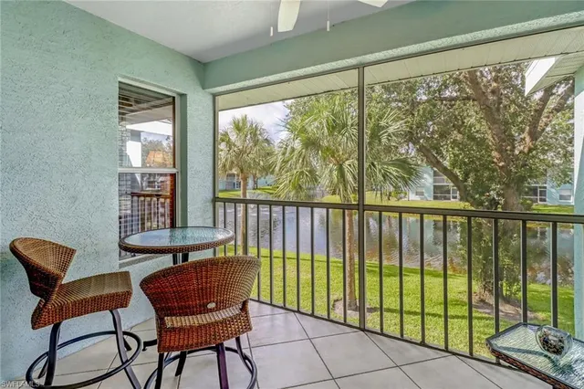 a view of a chairs and table in a balcony