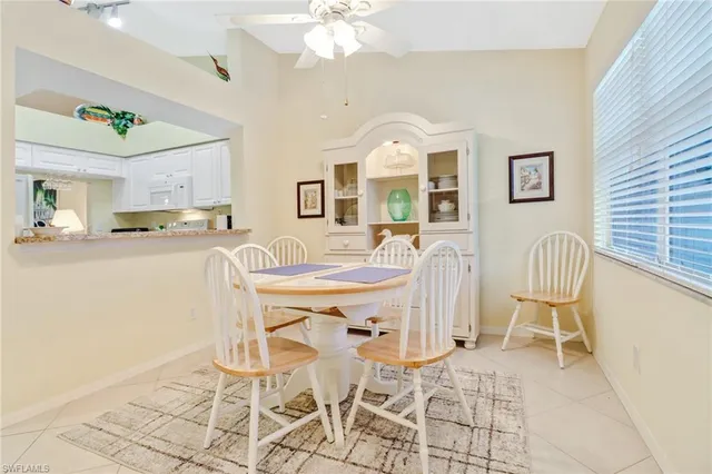 a view of a dining room with furniture and a chandelier