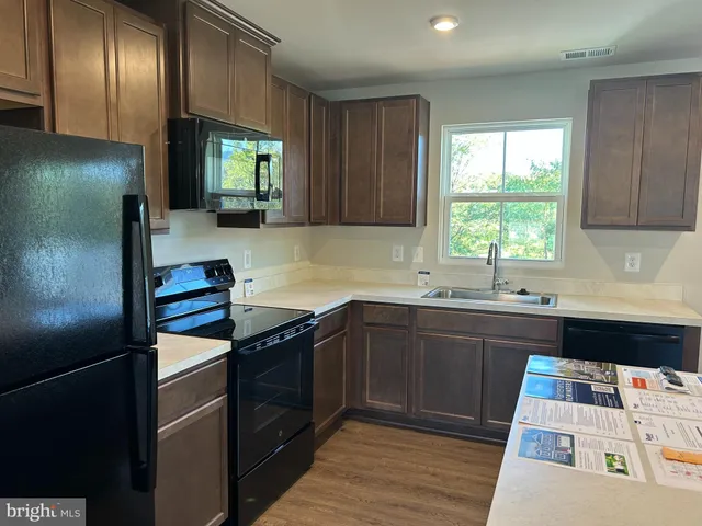 a kitchen with stainless steel appliances granite countertop a refrigerator and sink