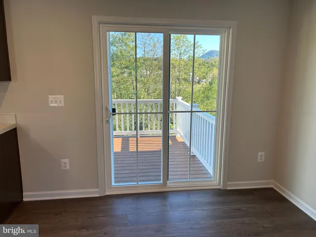 a view of a wooden door and wooden floor
