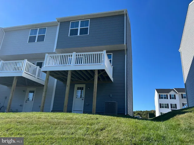 a view of a house with brick walls and a yard