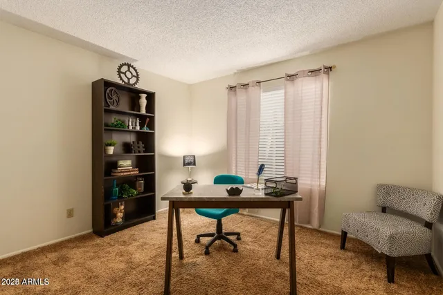 a work room with furniture and a window