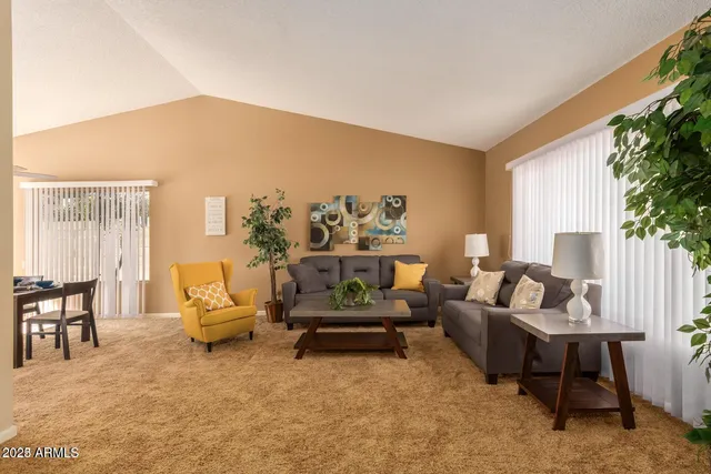 a living room with furniture and a potted plant