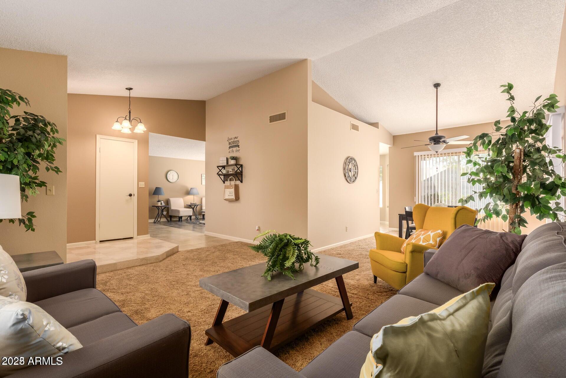 2221 West Rockwell Drive Chandler, AZ 85224 - Photo 4 of 14 a living room with furniture and a chandelier