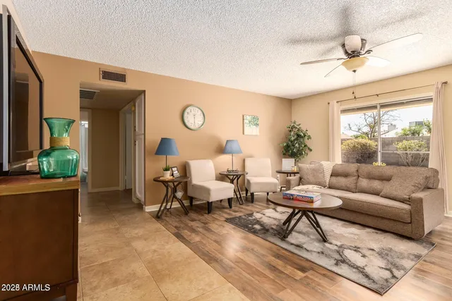 a living room with furniture and wooden floor