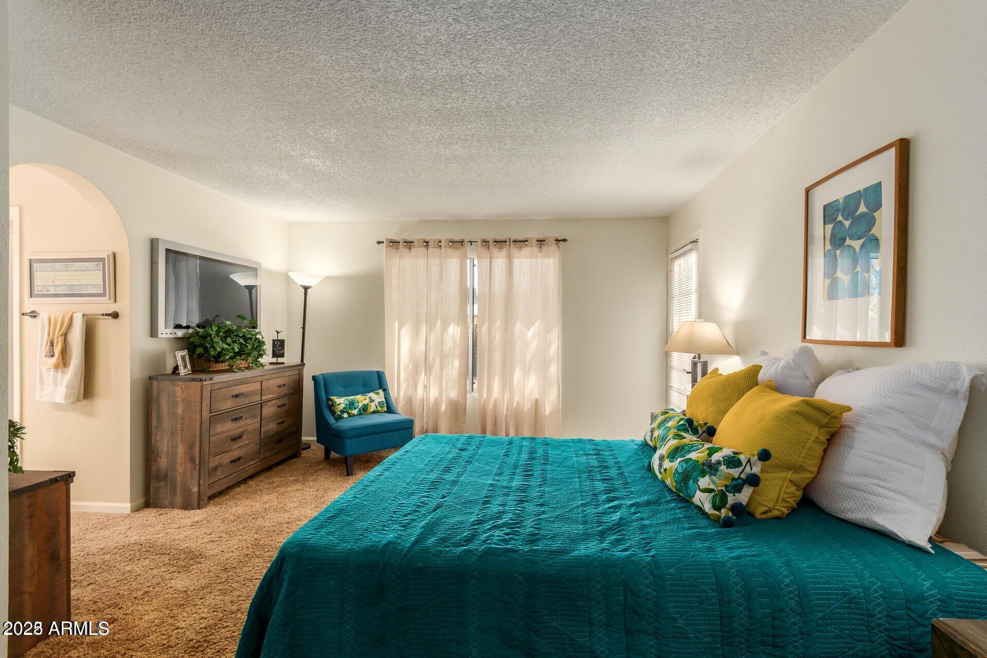 2221 West Rockwell Drive Chandler, AZ 85224 - Photo 8 of 14 a bedroom with a bed and a couch