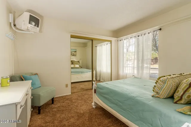 a bedroom with a bed and a window