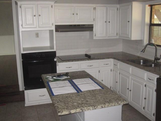 2801 Pyramid Circle Denison, TX 75020 - Photo 5 of 18 a kitchen with white cabinets