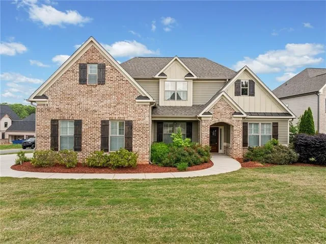 a front view of a house with a yard and garage