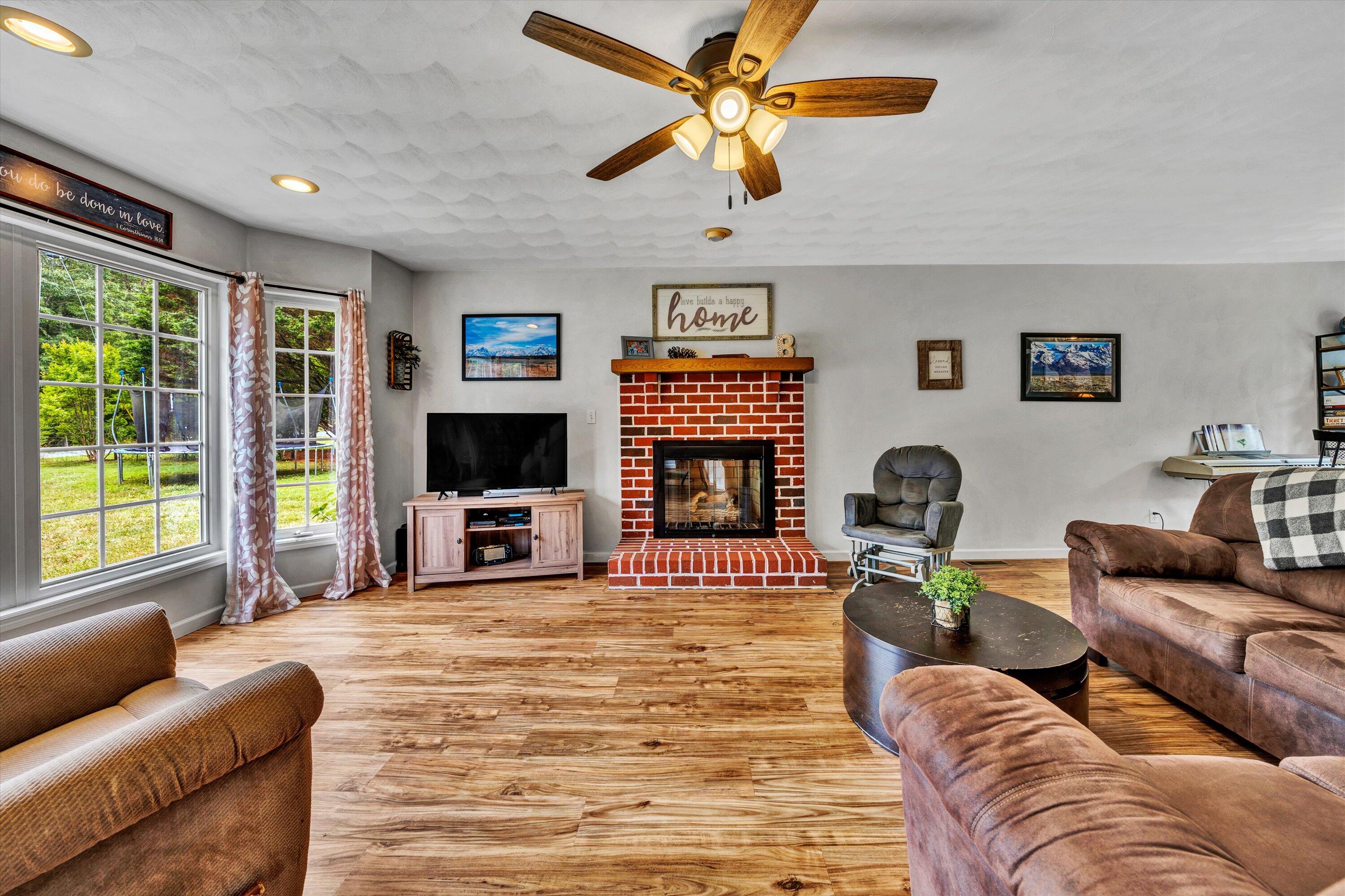 140 Charlie Road Hardy, VA 24101 - Photo 8 of 33 a living room with furniture flat screen tv and a fireplace