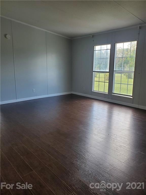 1282 Macedonia-Angelus Road Jefferson, SC 29718 - Photo 11 of 26 an empty room with wooden floor and windows