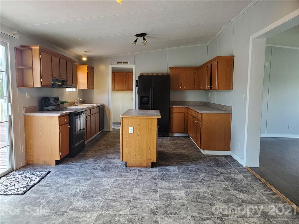 1282 Macedonia-Angelus Road Jefferson, SC 29718 - Photo 12 of 26 a kitchen with stainless steel appliances granite countertop a stove top oven a sink a counter top space and cabinets
