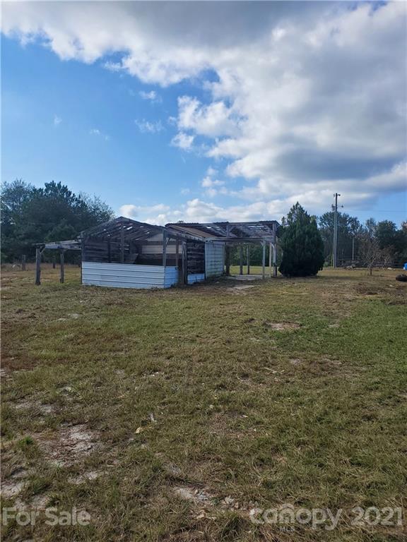 1282 Macedonia-Angelus Road Jefferson, SC 29718 - Photo 26 of 26 a view of a big yard with an buildings in the background