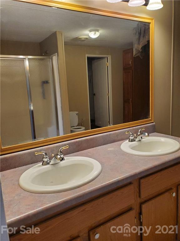 1282 Macedonia-Angelus Road Jefferson, SC 29718 - Photo 10 of 26 a bathroom with a sink and a mirror