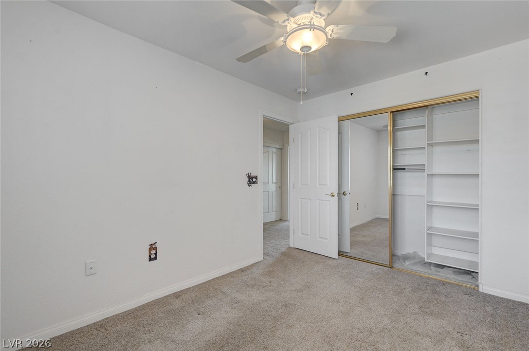 1479 Orange Jubilee Road Henderson, NV 89014 - Photo 24 of 36 A comfortable bedroom features plush carpeting and a large mirrored closet.