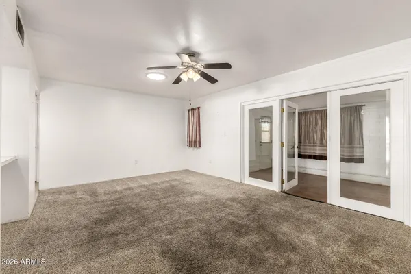 a view of an empty room with a ceiling fan