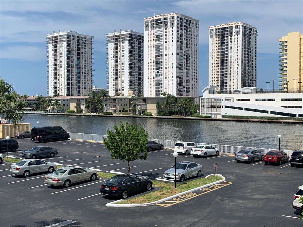 1000 Parkview Drive, Unit 319 Hallandale Beach, FL 33009 - Photo 1 of 16 a view of a lake with cars
