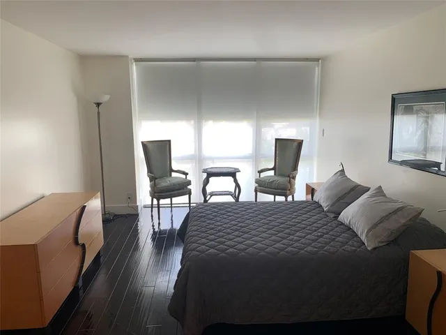 a bedroom with a bed a table and chair