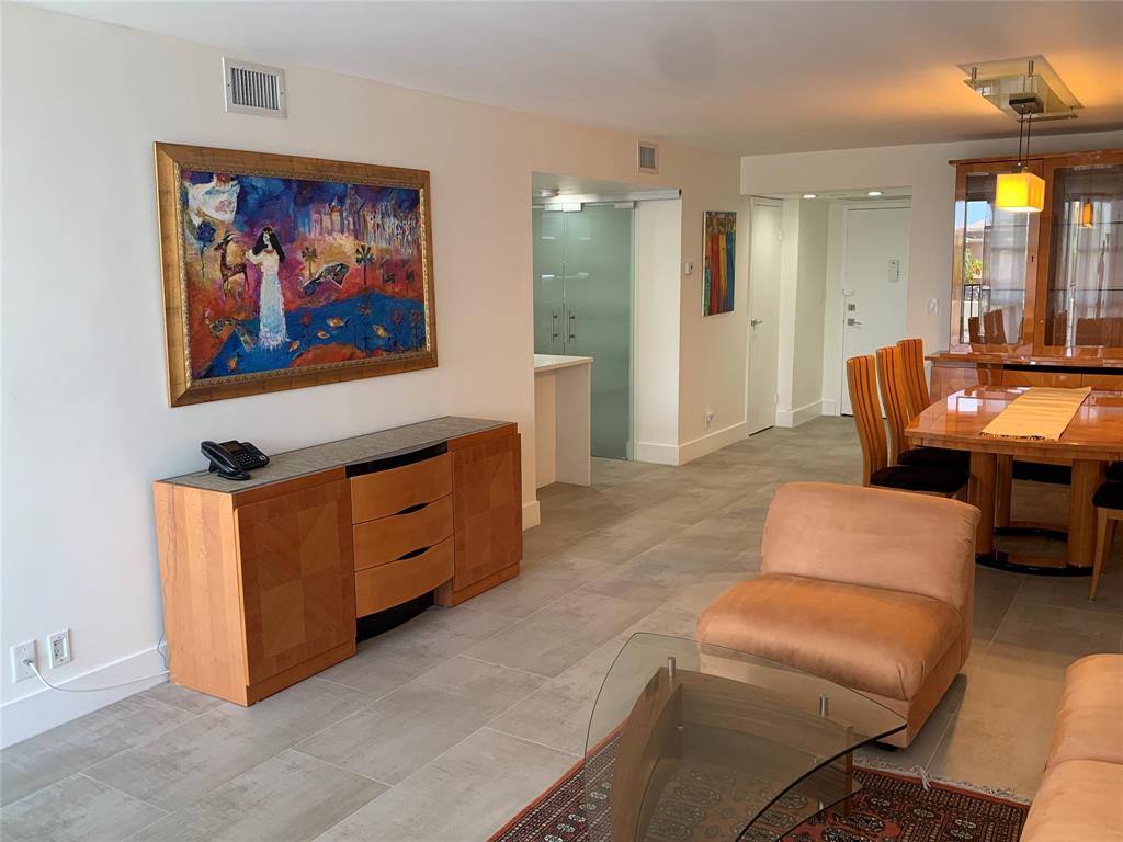 1000 Parkview Drive, Unit 319 Hallandale Beach, FL 33009 - Photo 2 of 16 a living room with furniture a couch and dresser