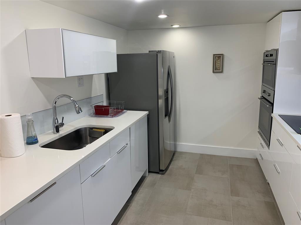 1000 Parkview Drive, Unit 319 Hallandale Beach, FL 33009 - Photo 4 of 16 a kitchen with a sink and refrigerator