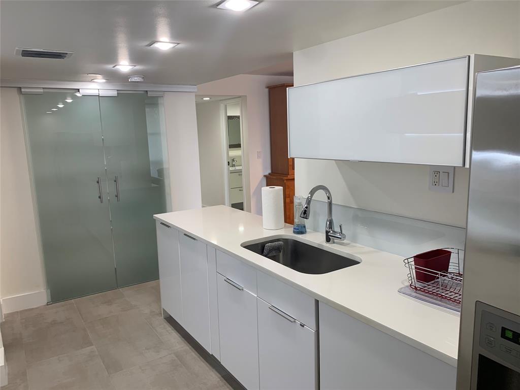 1000 Parkview Drive, Unit 319 Hallandale Beach, FL 33009 - Photo 5 of 16 a kitchen with a sink and a refrigerator