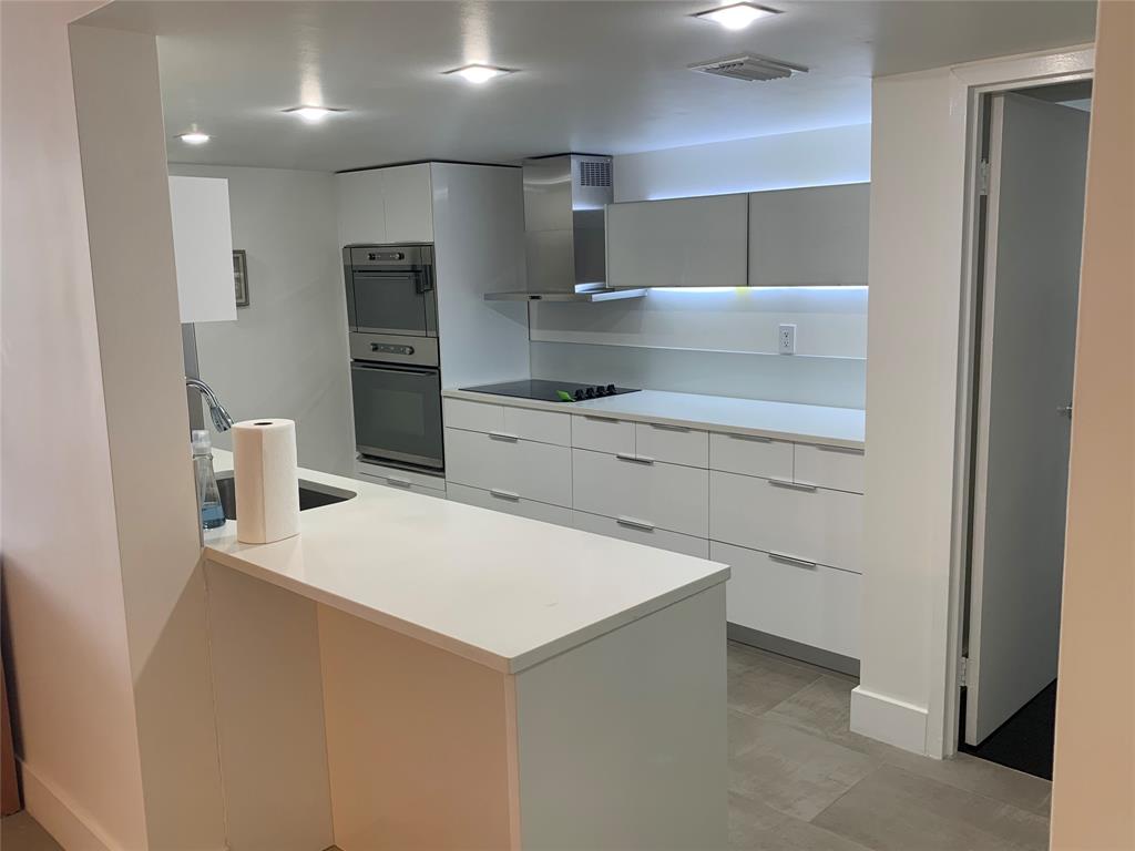 1000 Parkview Drive, Unit 319 Hallandale Beach, FL 33009 - Photo 6 of 16 a kitchen with stainless steel appliances a refrigerator and a stove