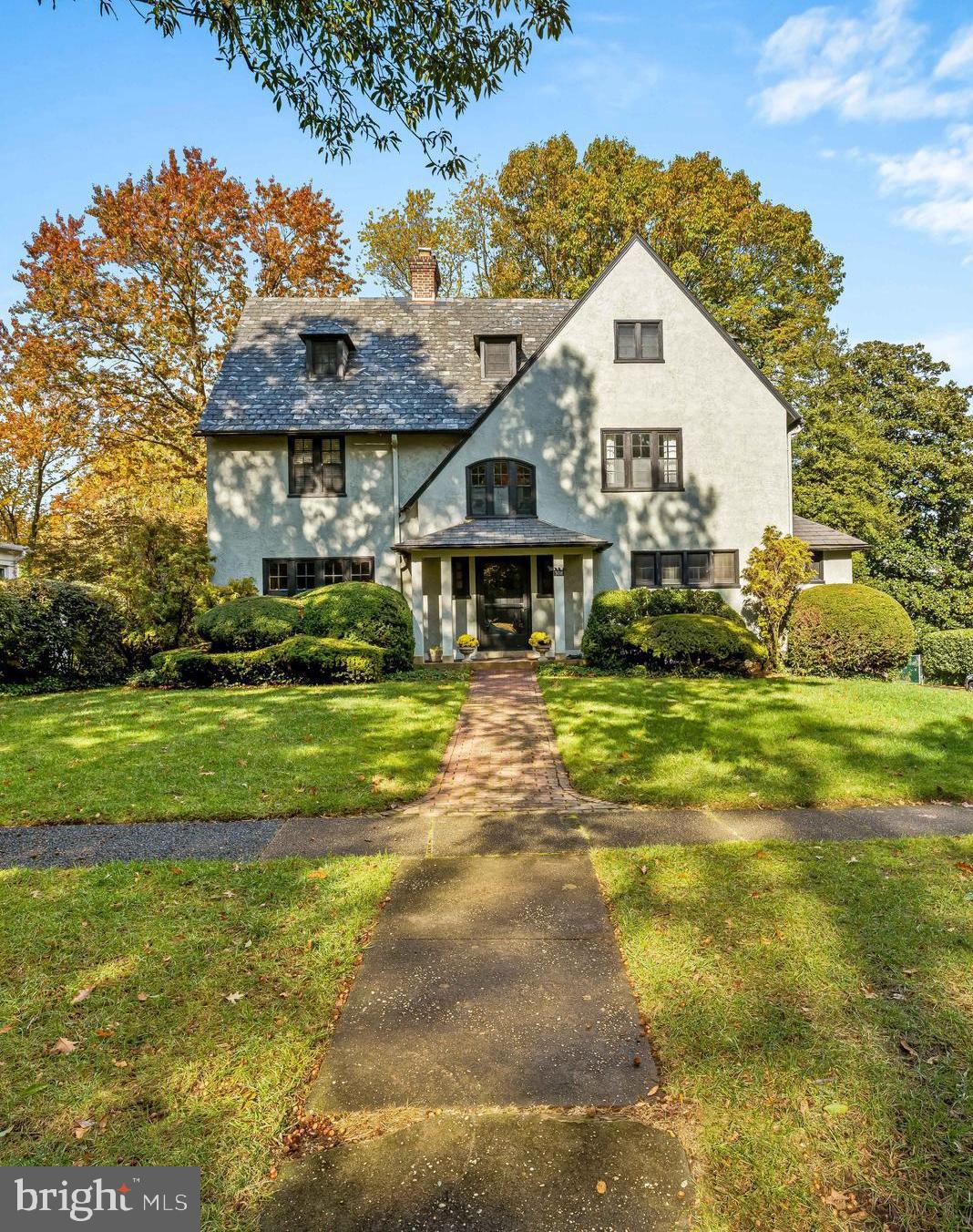 a view of a big house with a big yard and potted plants