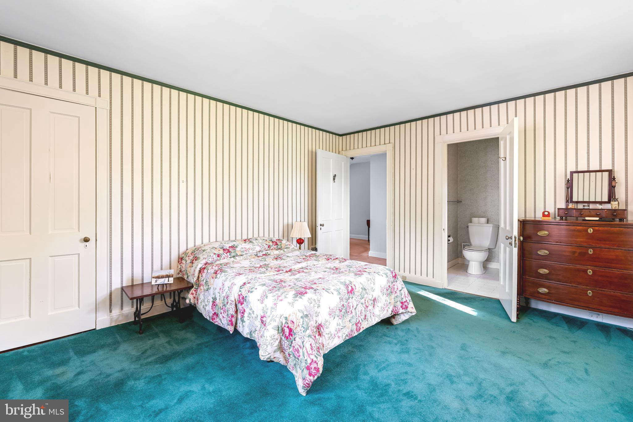 308 Northfield Place Baltimore, MD 21210 - Photo 22 of 41 a bed sitting in a spacious bedroom next to a window and a chair