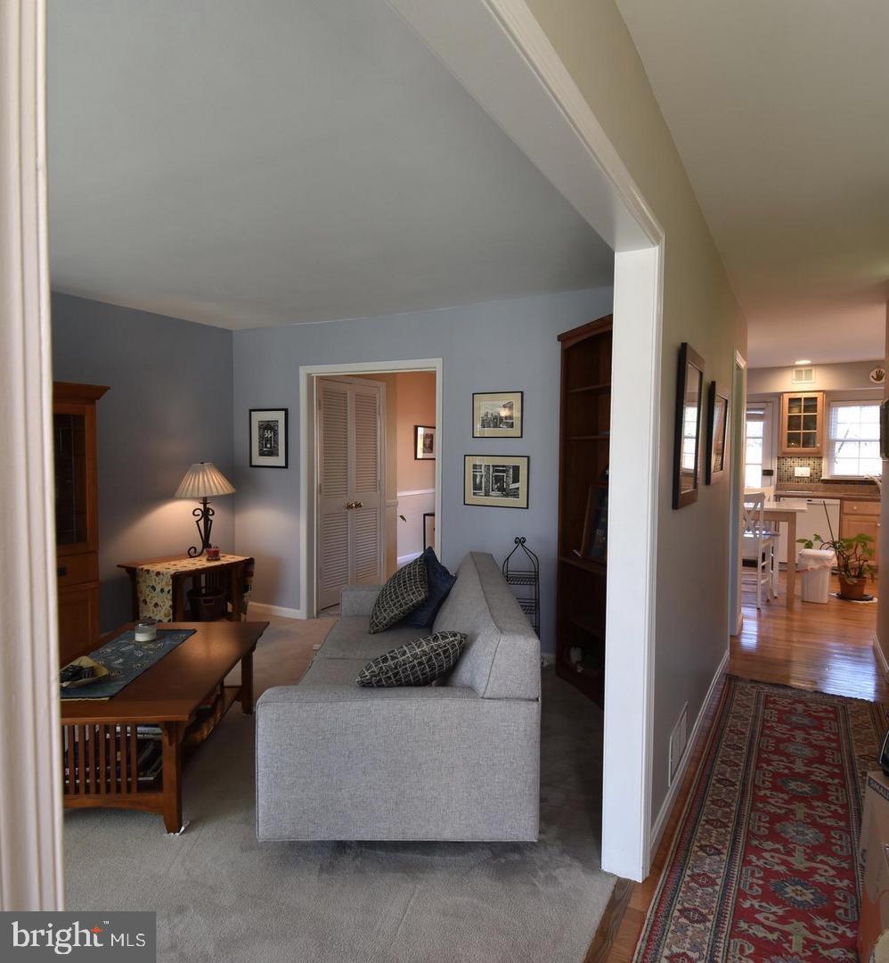 8244 Carrleigh Parkway Springfield, VA 22152 - Photo 8 of 25 a living room with furniture and a rug