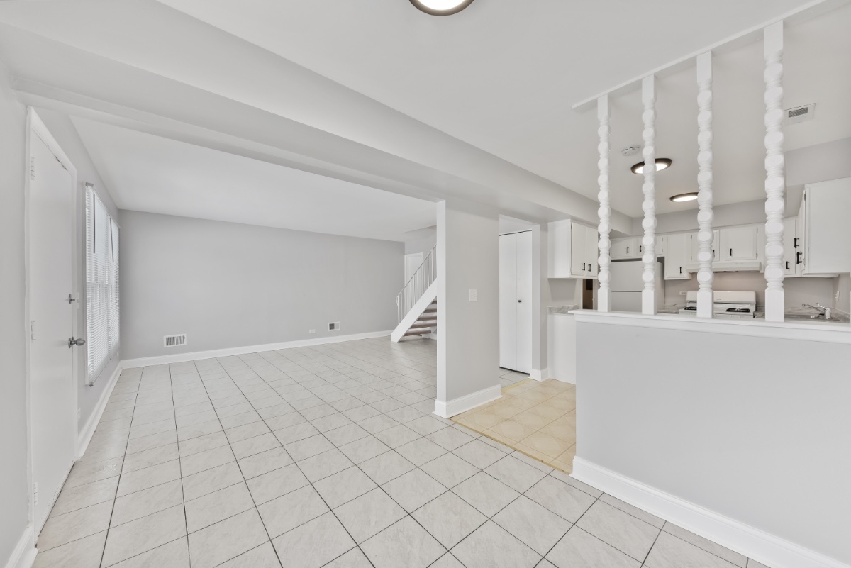 1681 Queensbury Circle Hoffman Estates, IL 60169 - Photo 4 of 13 a view of a kitchen with white cabinets and entryway