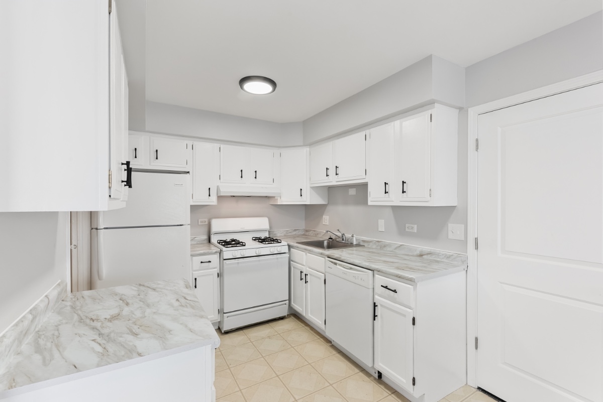1681 Queensbury Circle Hoffman Estates, IL 60169 - Photo 6 of 13 a kitchen with cabinets appliances and a sink