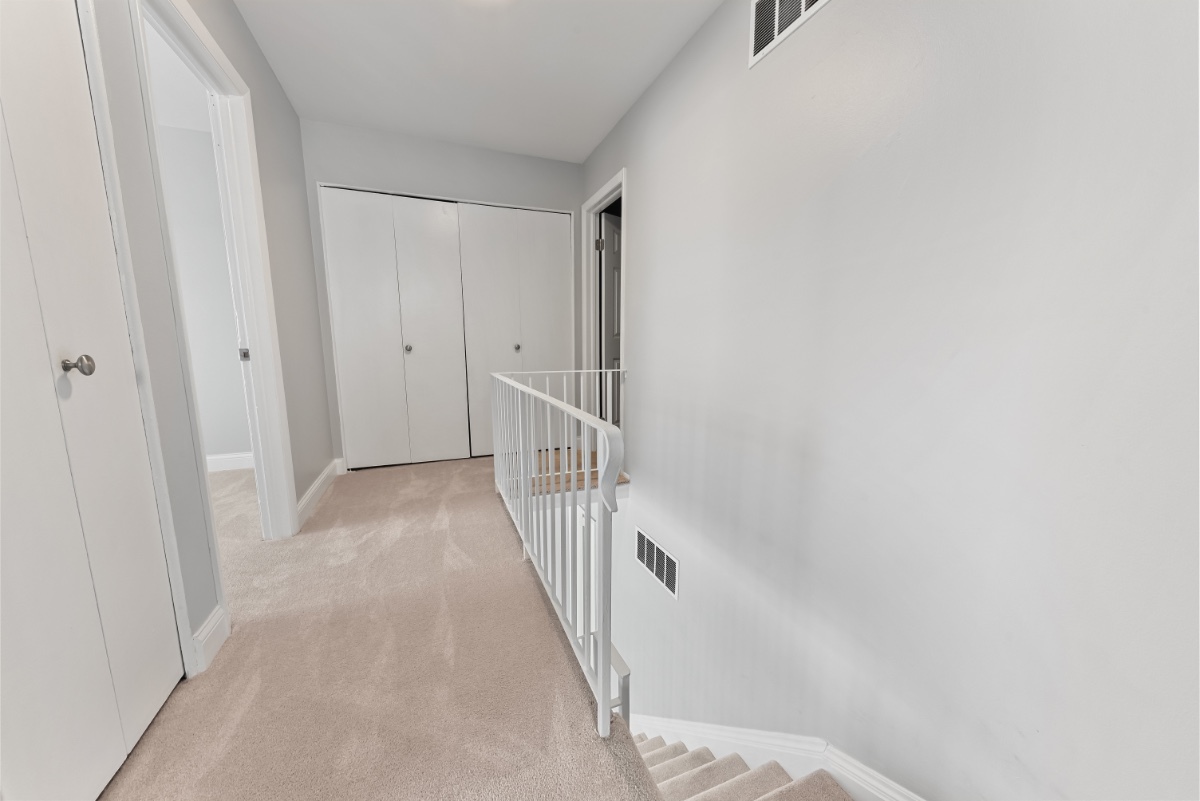 1681 Queensbury Circle Hoffman Estates, IL 60169 - Photo 7 of 13 a view of a hallway with a white door