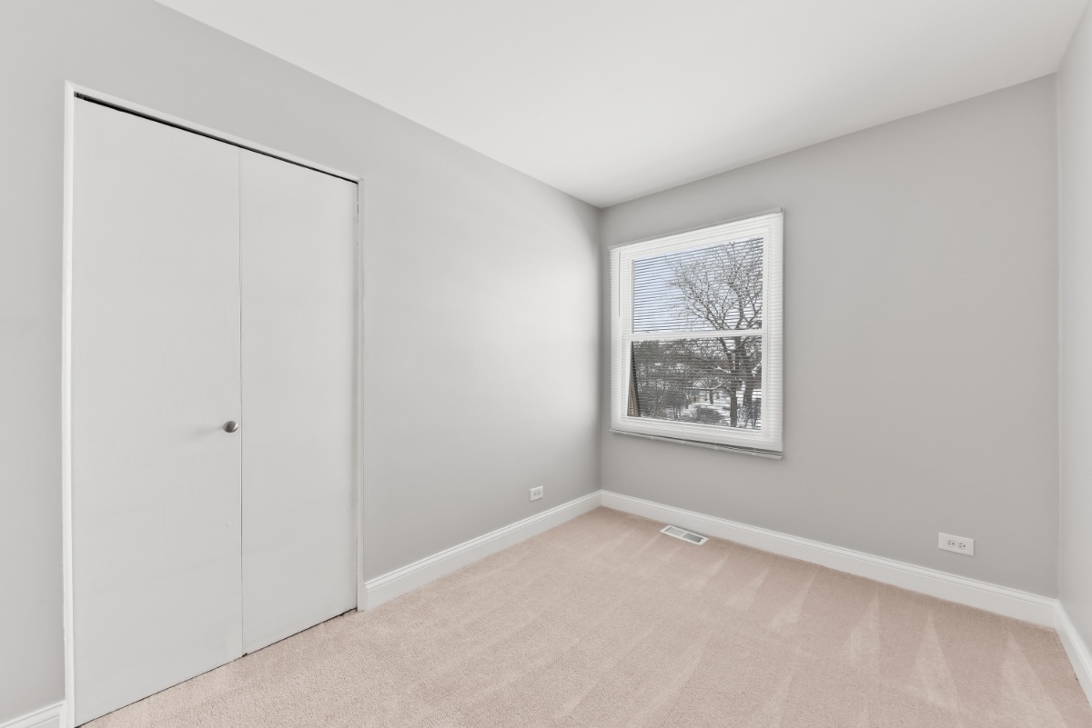 1681 Queensbury Circle Hoffman Estates, IL 60169 - Photo 8 of 13 a view of a big room with windows and closet