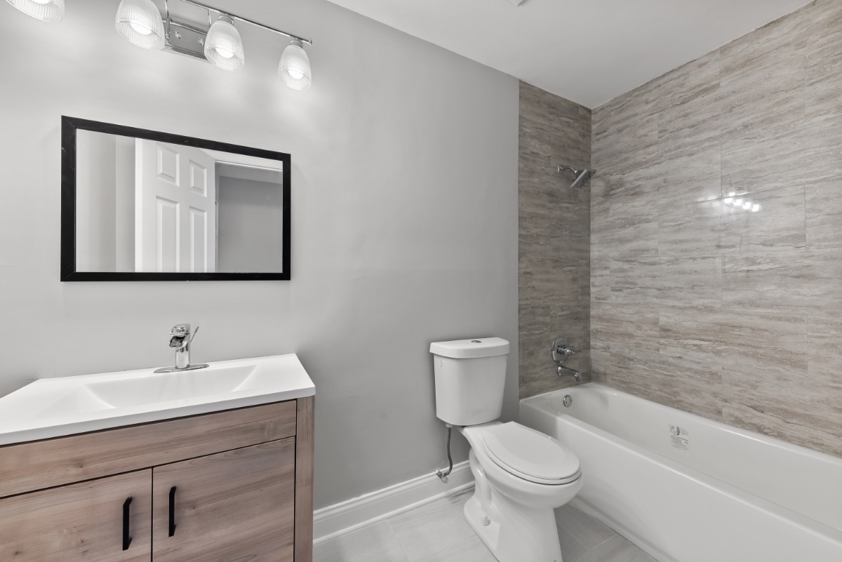 1681 Queensbury Circle Hoffman Estates, IL 60169 - Photo 10 of 13 a bathroom with a toilet sink and mirror