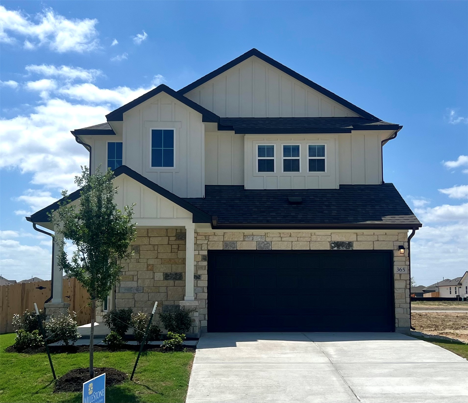 365 Young Street Buda, TX 78610 - Photo 1 of 27 a front view of a house with a garden
