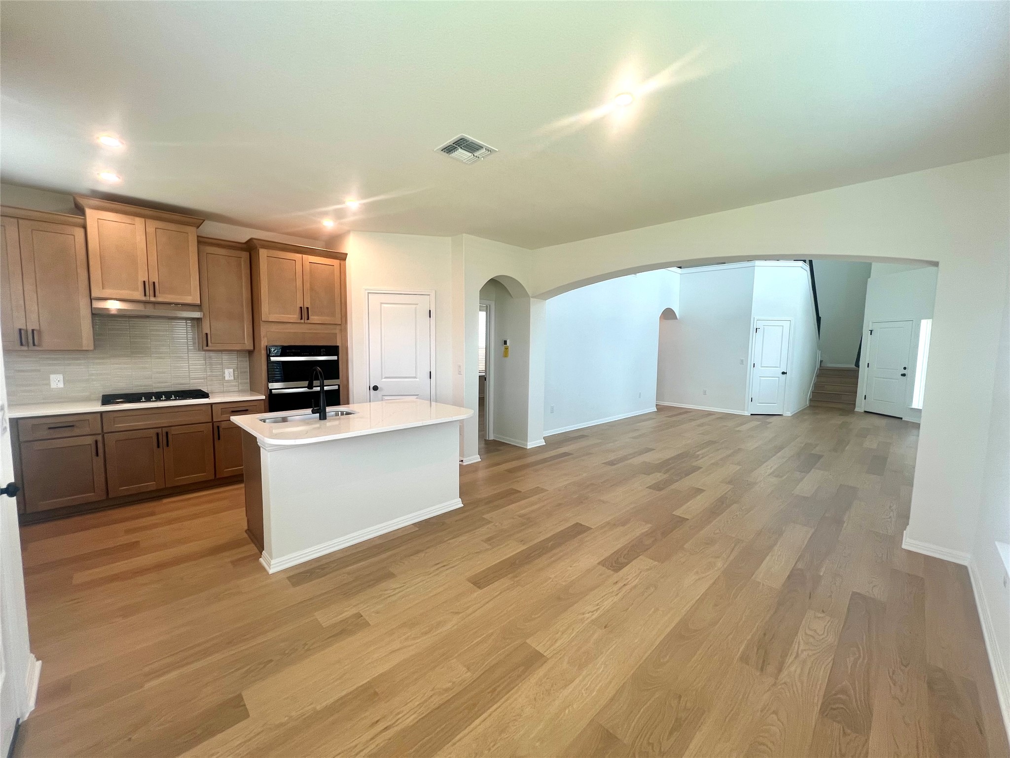 365 Young Street Buda, TX 78610 - Photo 11 of 27 a large kitchen with cabinets and stainless steel appliances