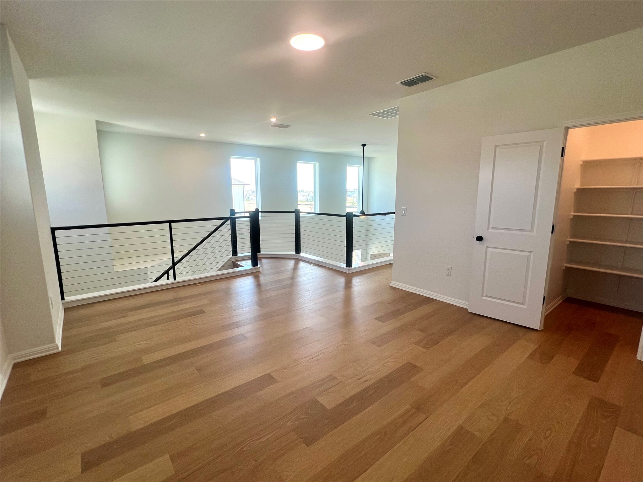 365 Young Street Buda, TX 78610 - Photo 14 of 27 a view of empty room with wooden floor